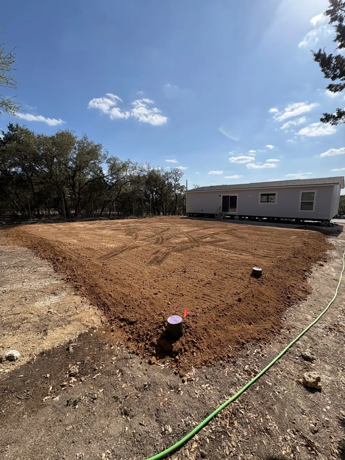Completed septic installation with clean-outs set and yard restored to grade
